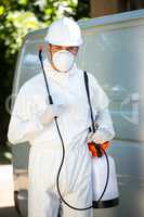 Portrait of pest control man standing next to a van