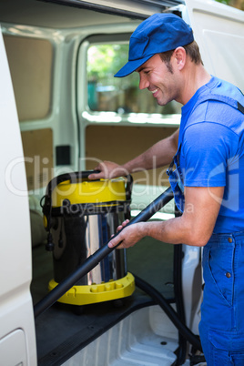 Happy janitor cleaning the car