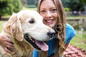 Smiling woman with her pet dog in park