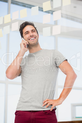 Man talking on phone with hand on hip