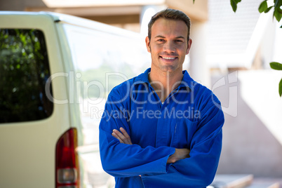 Mechanic standing near his car