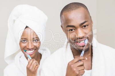 Young couple brushing teeth