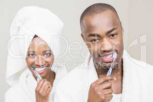 Young couple brushing teeth