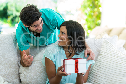 Man giving a surprise gift to woman