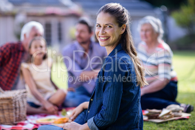 Happy woman having a picnic with her family