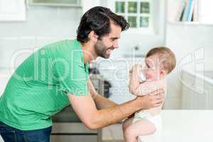 Father with son drinking milk at kitchen table