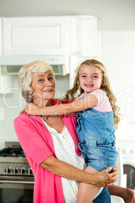 Happy granny carrying girl