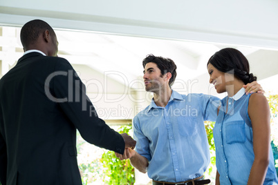 Real estate agent giving house keys to the couple