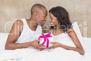 Young man presenting gift to woman
