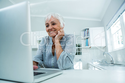 Happy senior woman with laptop