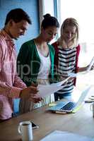 Colleagues discussing at their desk