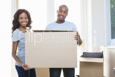Young couple holding carton boxes