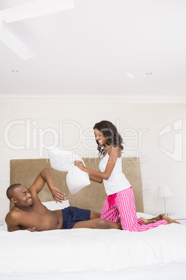 Young couple having a pillow fight