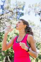 Young fit woman drinking water