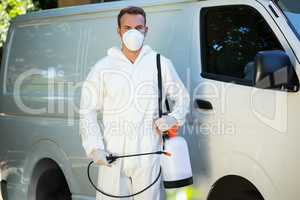 Portrait of pest control man standing next to a van