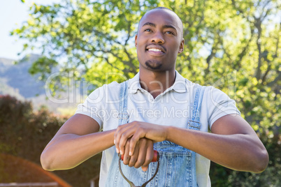 Young man posing with a shovel