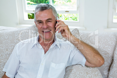 Portrait of happy senior man talking on mobile phone