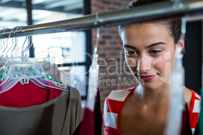 Woman selecting an apparel while shopping for clothes