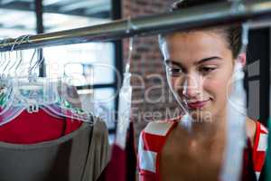 Woman selecting an apparel while shopping for clothes