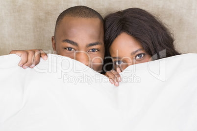 Portrait of young couple holding blanket