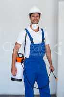 Portrait of happy manual worker with insecticide