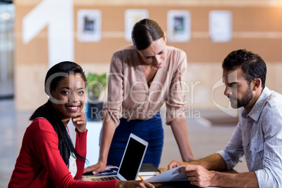 Team of colleagues discussing at their desk