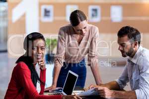 Team of colleagues discussing at their desk