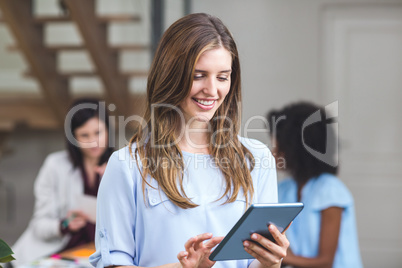 Happy businesswoman using digital tablet