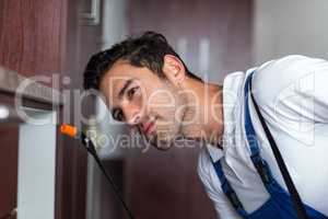 Confident worker using crop sprayer