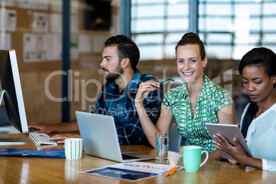 Young man and women sitting at their desk