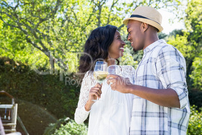 Young couple toasting glasses of wine