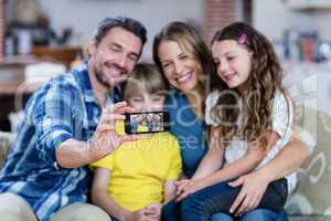 Happy family taking a selfie on mobile phone