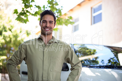 Portrait of smiling pesticide workerwith hand on hip