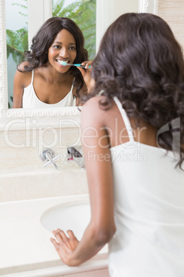 Young woman brushing her teeth