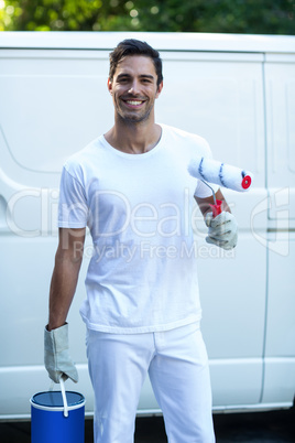 Portrait of happy painter with equipment