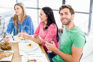 Man sitting with friends at dinning table