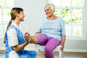 Happy nurse assisting aged woman