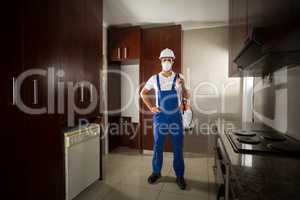 Portrait of pesticide worker with hand on hip