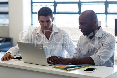 Colleagues working together at their desk