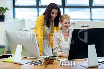 Colleagues working on computer together