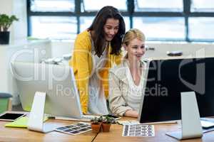 Colleagues working on computer together