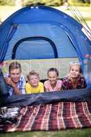 Happy family lying in a tent