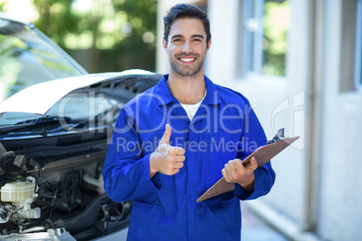 Portrait of confident engineer showing thumbs up