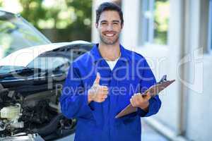 Portrait of confident engineer showing thumbs up