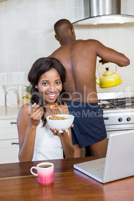 Young woman having breakfast in the kitchen