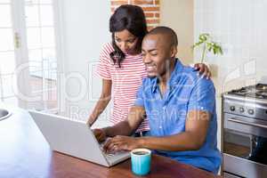 Young couple using laptop