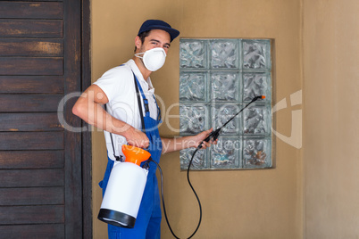 Portrait of worker spraying chemical