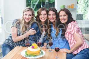 Portrait of beautiful women with birthday cake and glass of red