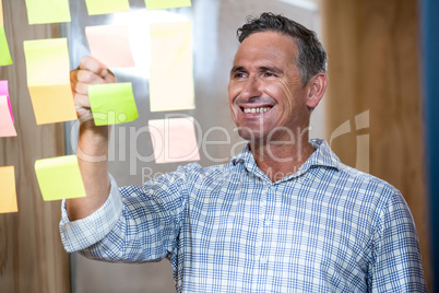 Man writing on sticky notes