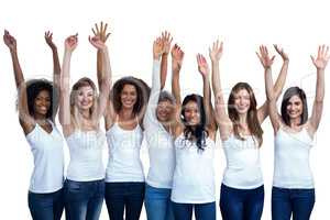 Happy multiethnic women standing with their hands raised